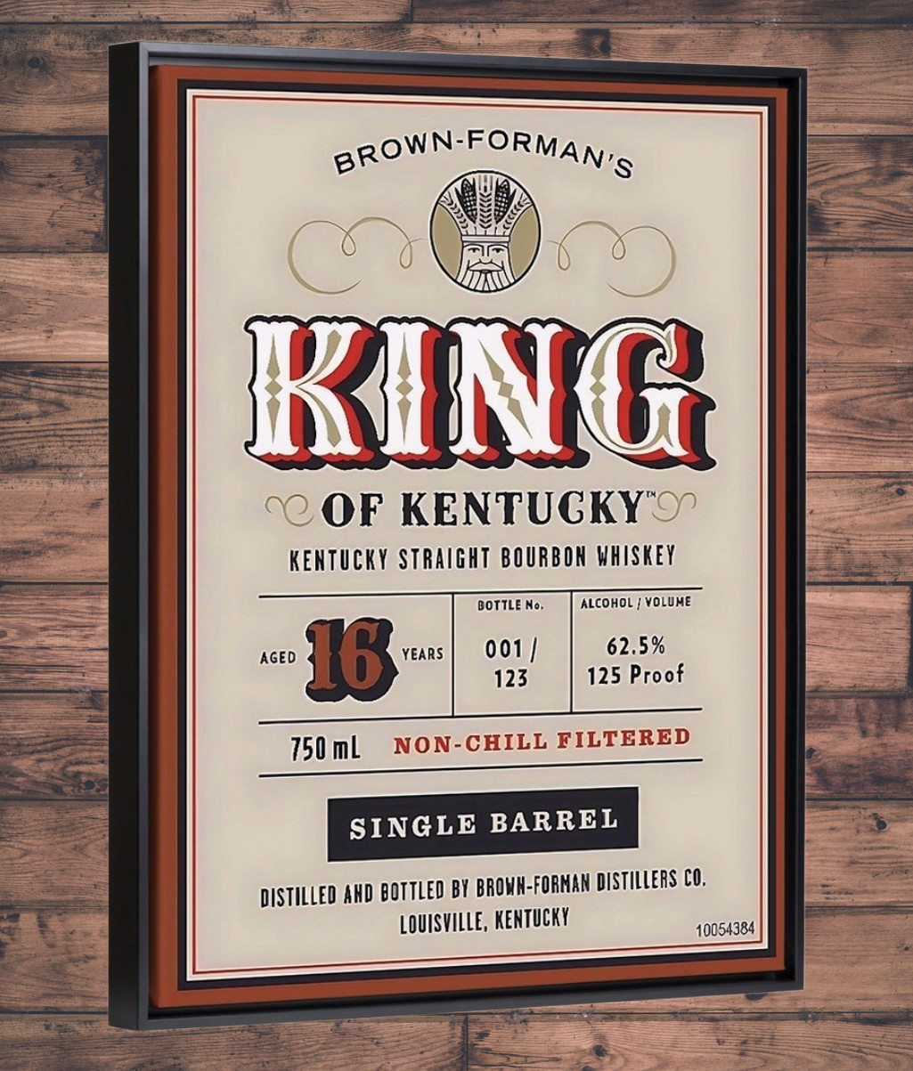 Framed Brown-Forman's King of Kentucky whiskey label on a wooden wall.