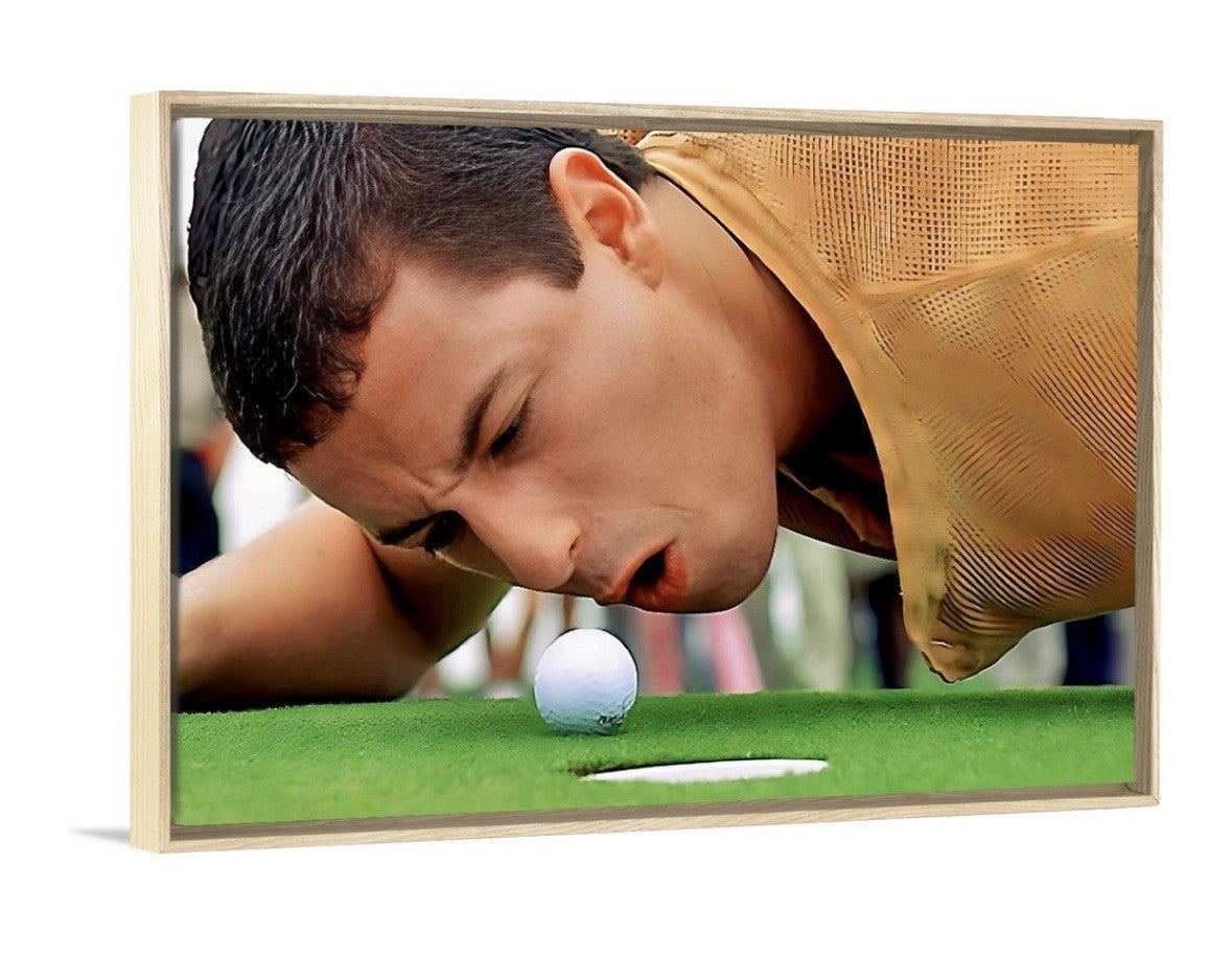 Man leaning over to look at a golf ball on a green surface